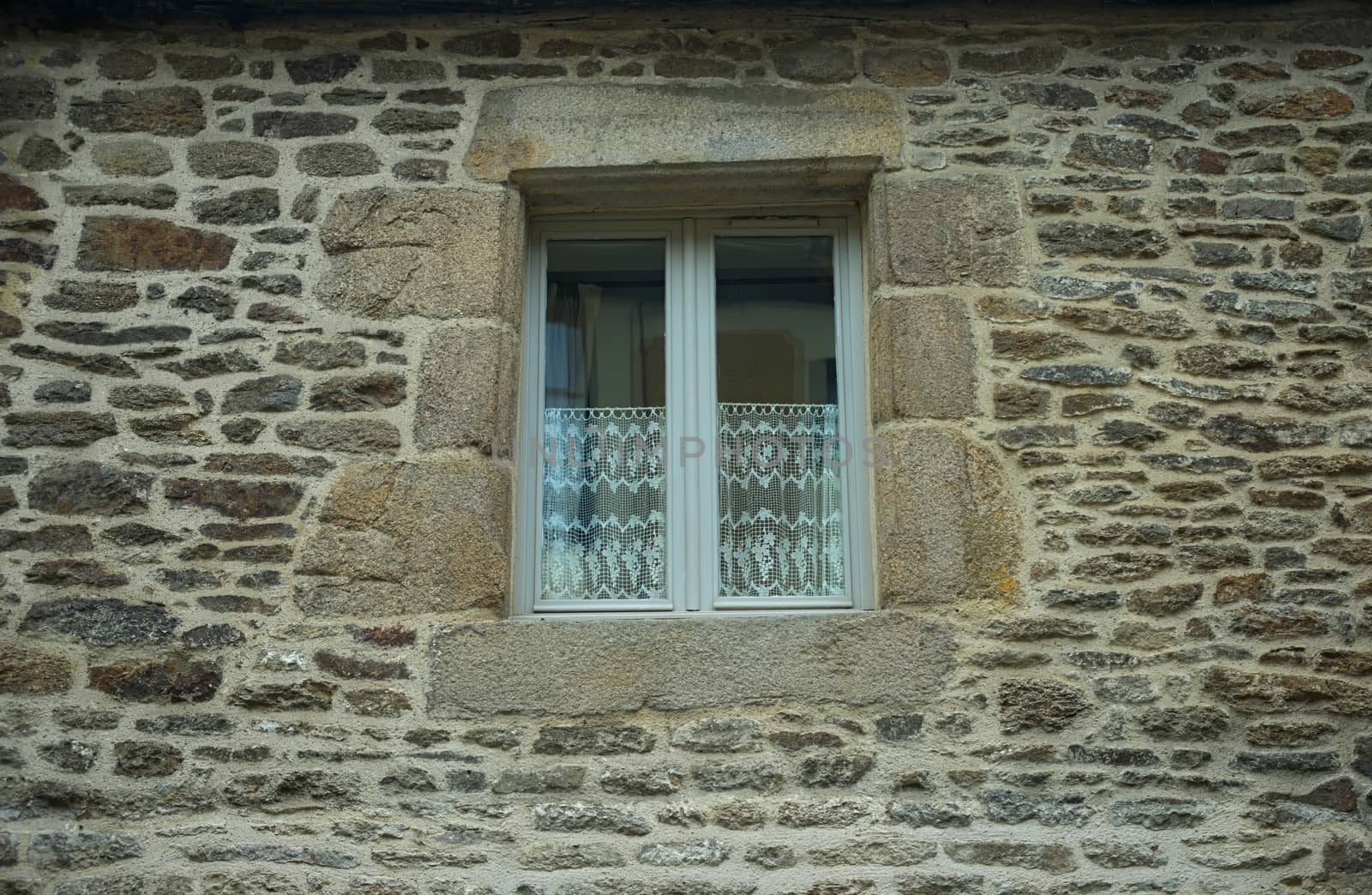 White wooden window on old house stone wall by sheriffkule