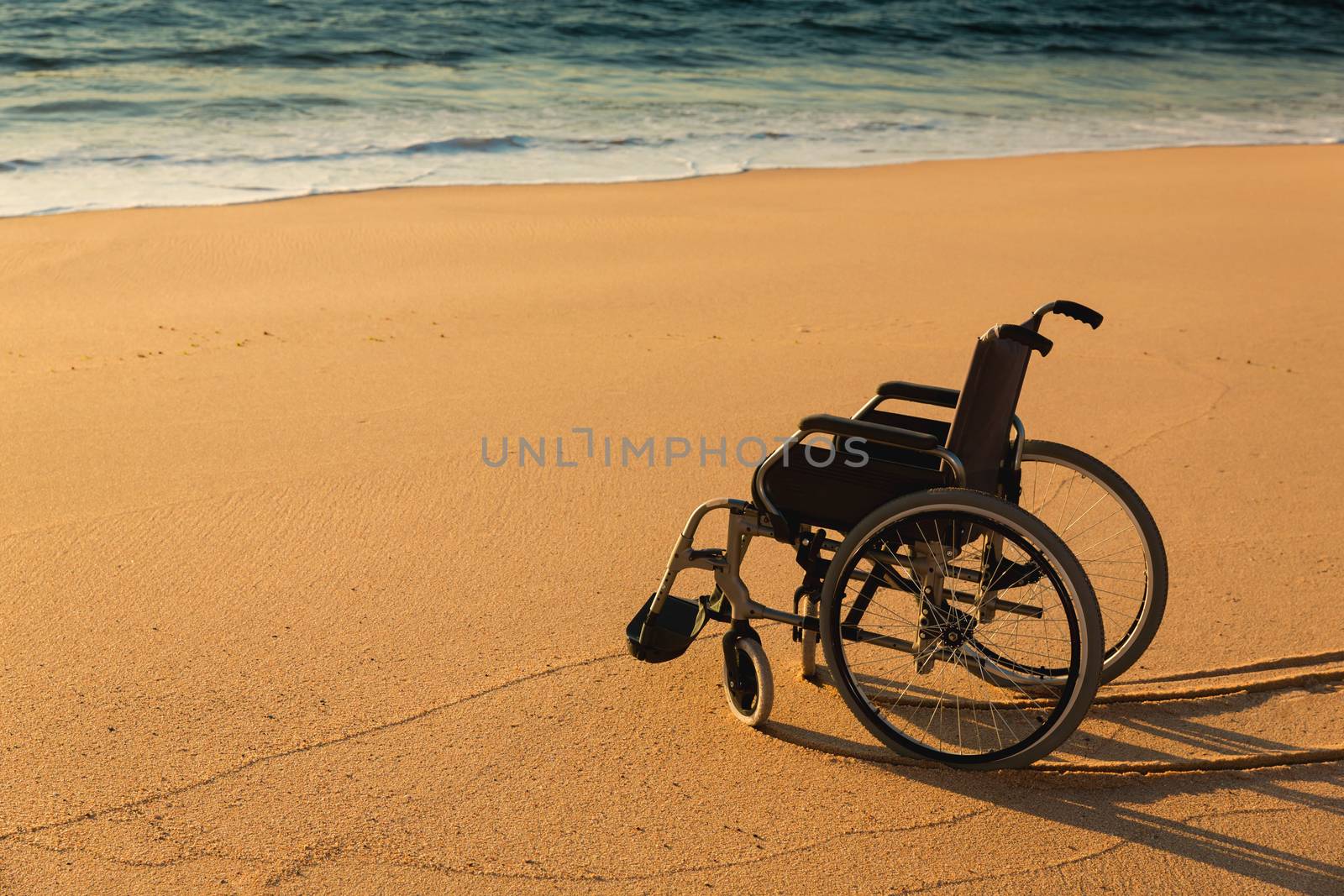 Comceptual image of a wheelchair on the beach