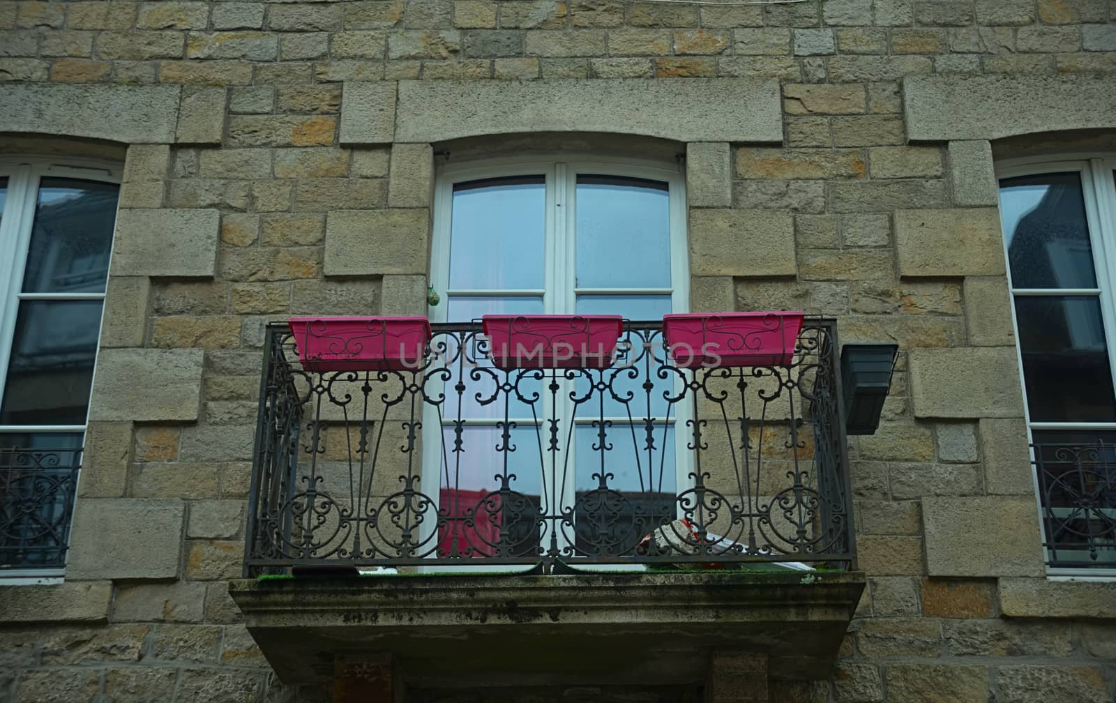 Small terrace with balcony door on old stone house