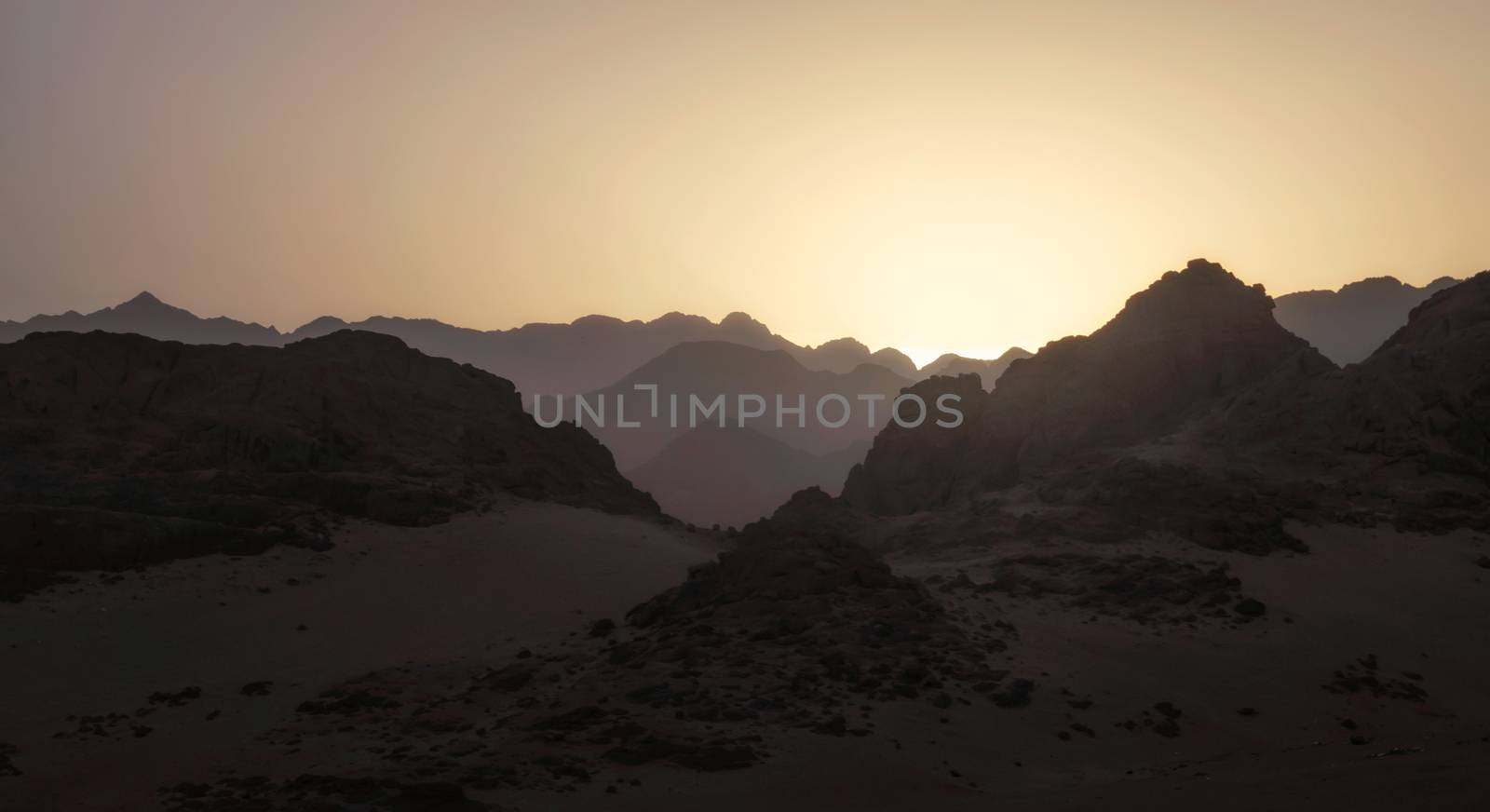 night desert landscape with rocky mountains and sunset sky with clouds in Sharm El Sheikh Egypt
