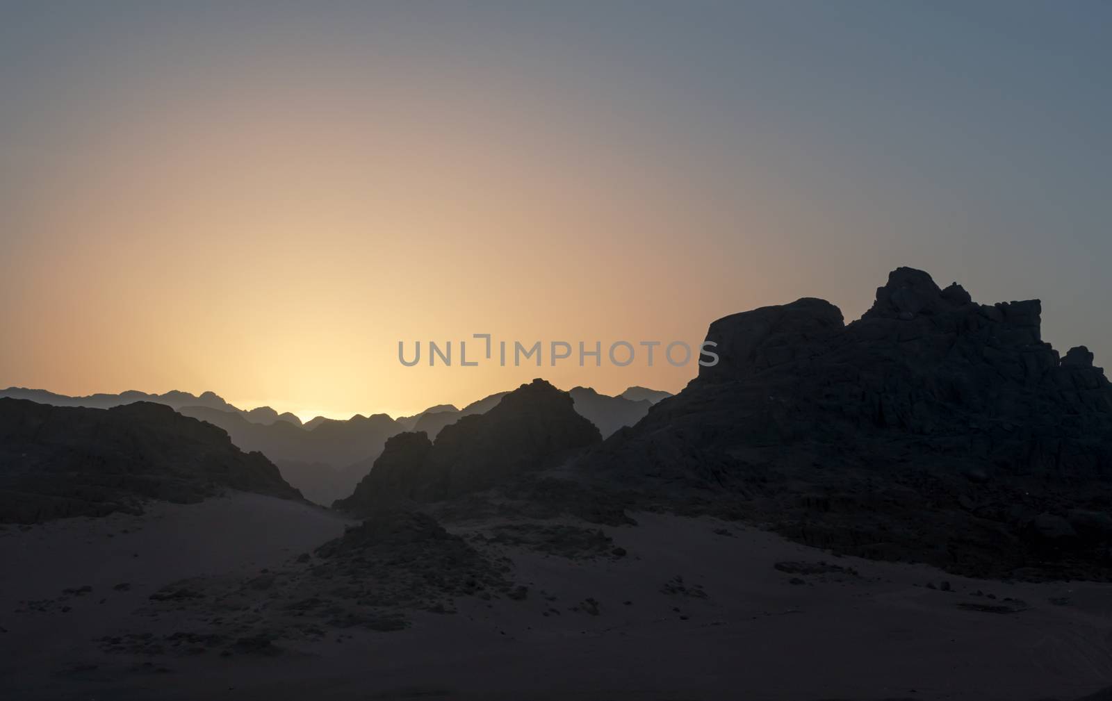 night desert landscape with rocky mountains and sunset sky with clouds in Sharm El Sheikh Egypt