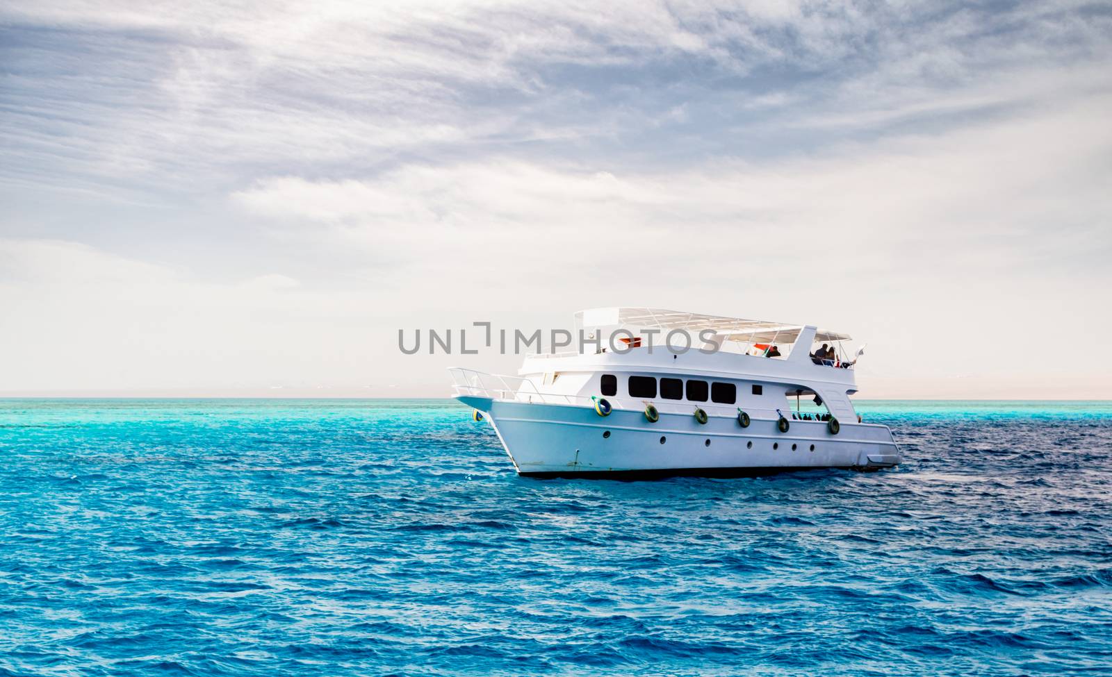 white cruise tourist boat on the background of the coast in the Red Sea in Sharm El Sheikh Egypt