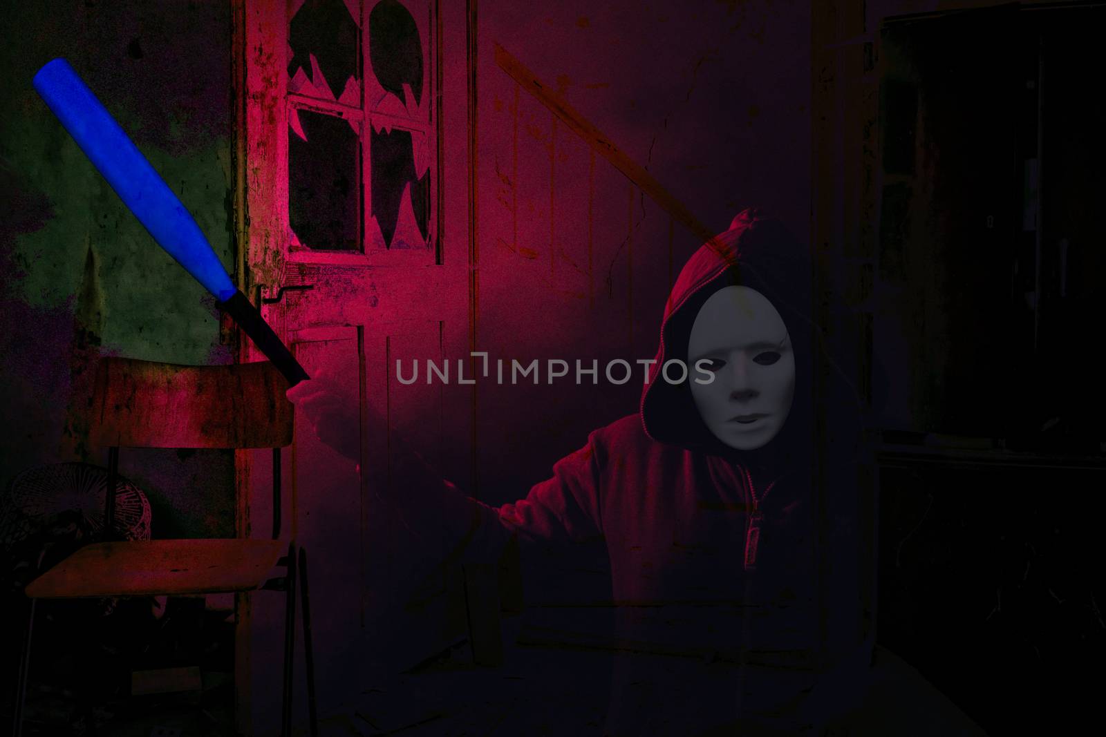 Halloween dangerous masked scary person holding a blue bat and standing in a demolished room