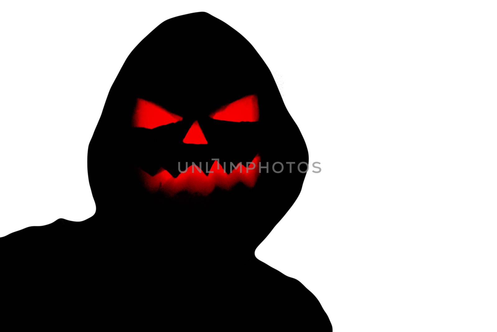 Halloween black hooded silhouette with a evil scary pumpkin face isolated on a white background