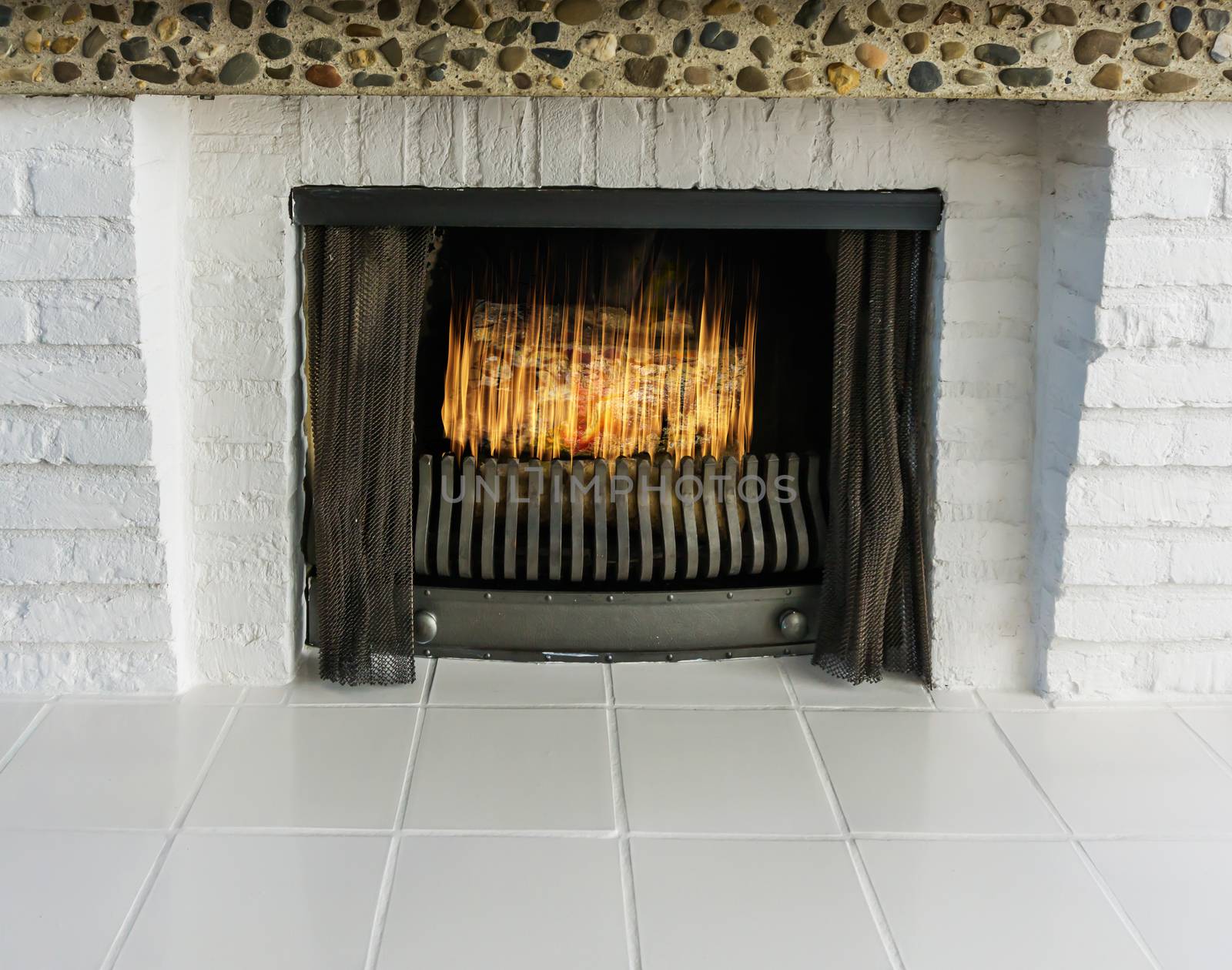Burning fire place with white bricks and white tiling Retro style but modern look background by charlottebleijenberg
