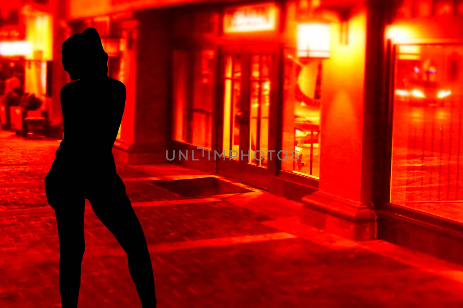 Silhouette of a sexy young hooker girl standing on the streets in front of the red windows by charlottebleijenberg