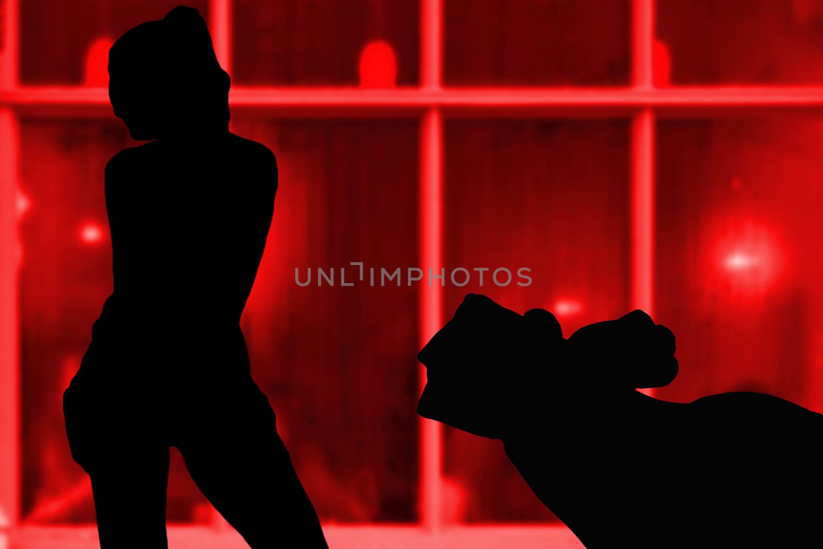 Hand giving money to a sexy young girl silhouettes on in front of a red window background