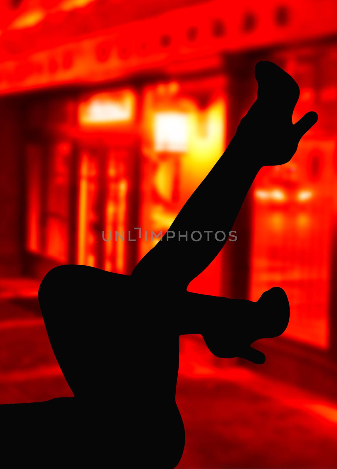 Silhouette of some sexy feminine legs on the street in front of red windows hooker street background