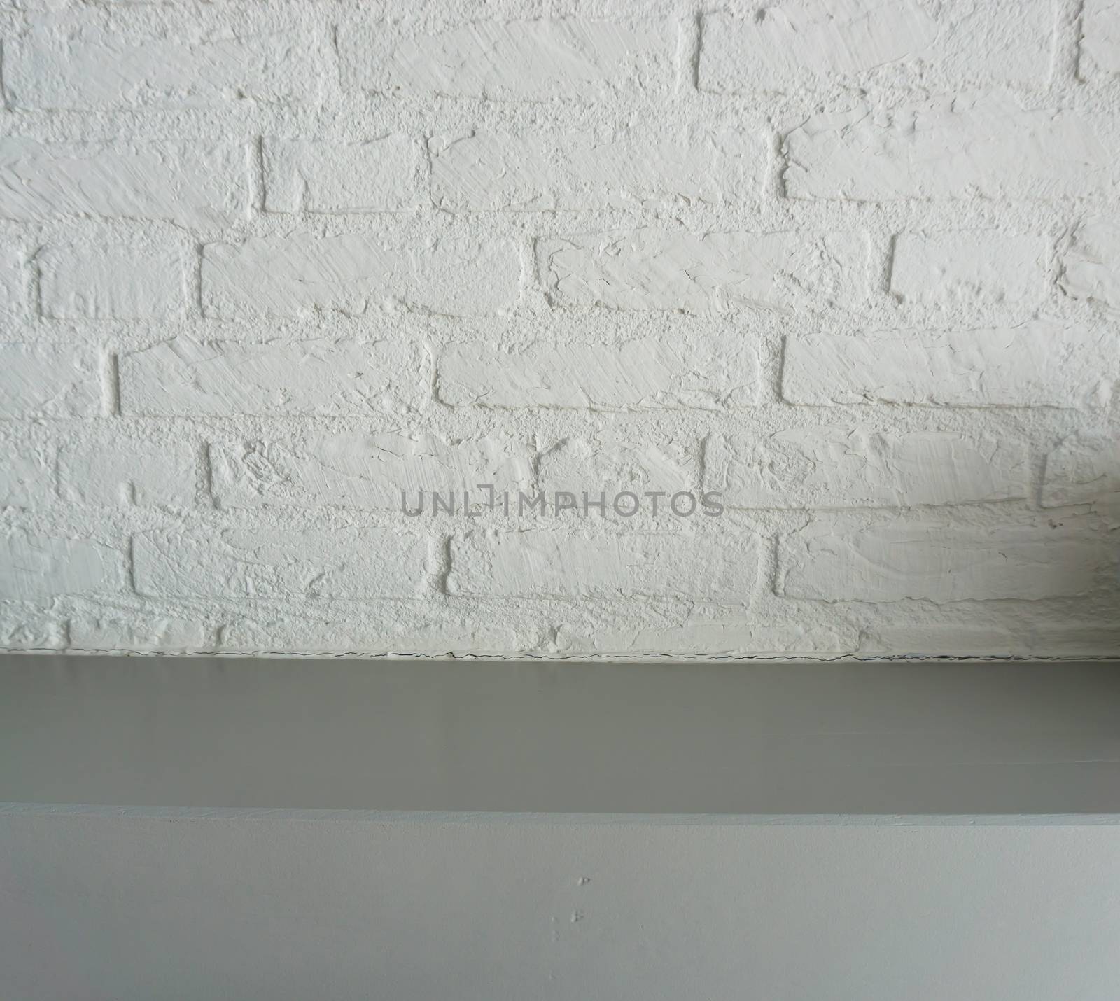 empty surface grey wooden table top with a white brick wall background