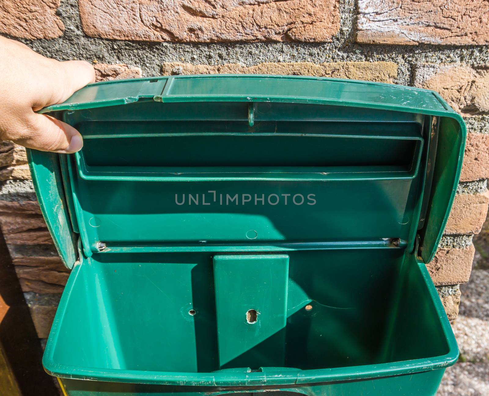 Green empty open mailbox closeup with nothing inside background texture