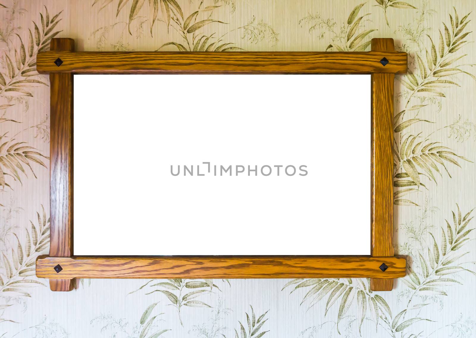 empty brown wooden picture frame hanging on a wall with decorated wallpaper background