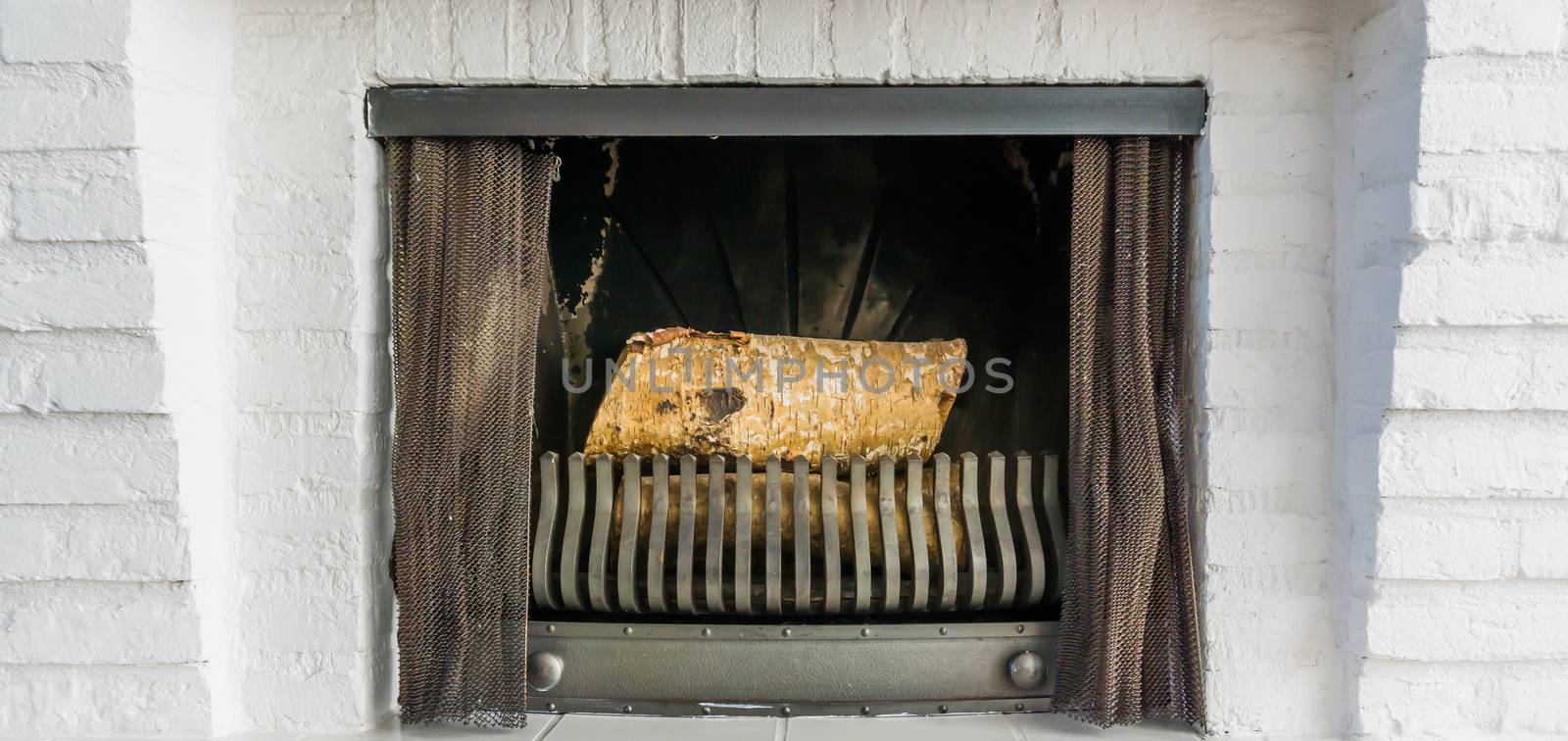 unlit Fireplace closeup background with wooden tree logs inside