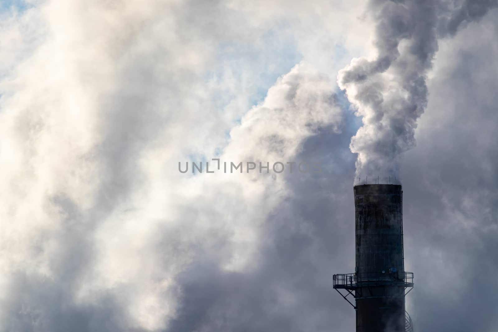 Smoke Billows From an Industrial Smokestack by colintemple