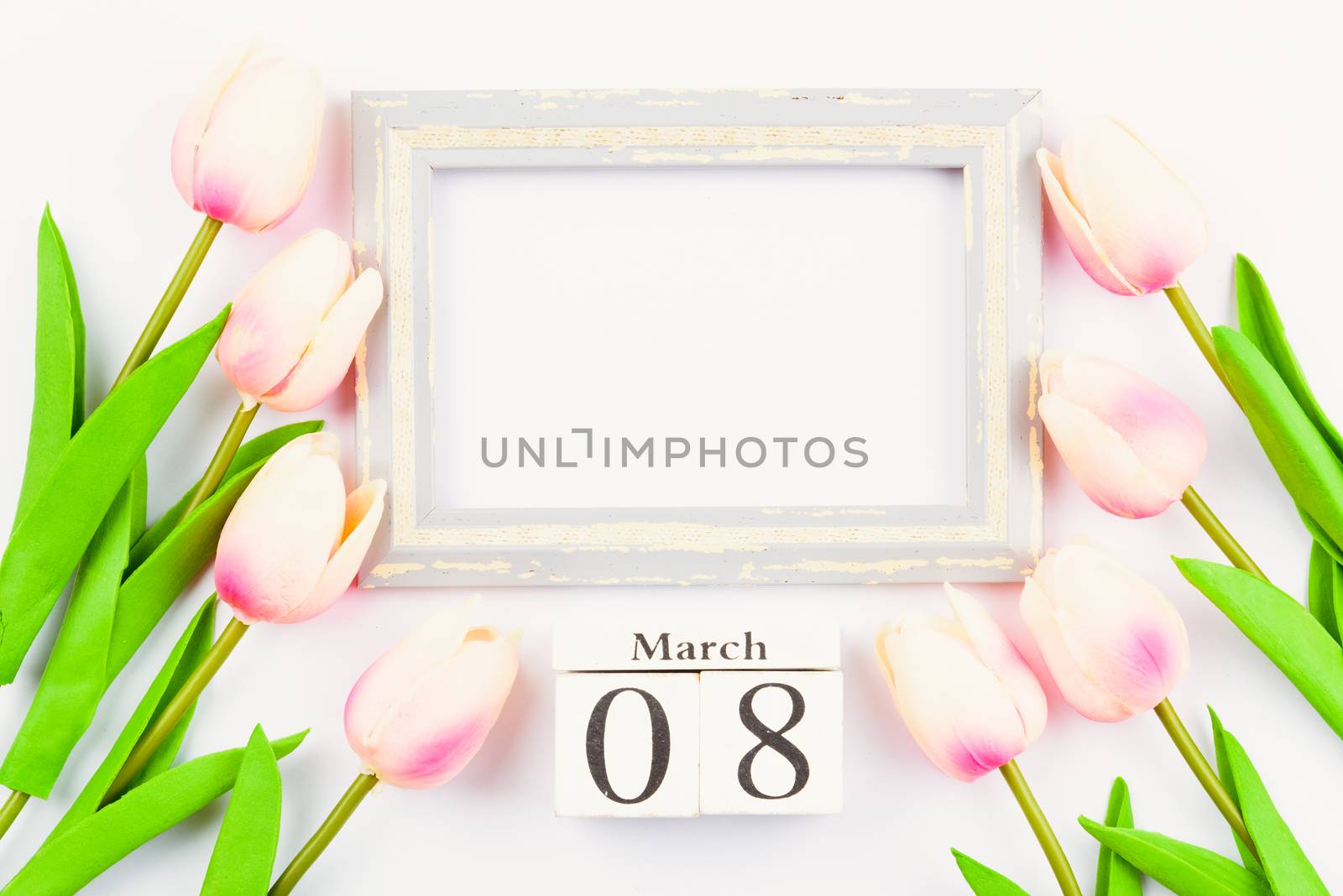 Happy Women's Day, Mother's Day and Valentine's Day concept. top view flat lay Tulip flower and photo frame on white background, copy space for your text