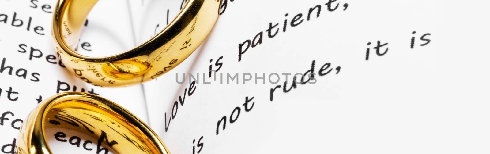 Two golden wedding rings on Holy bible book close up