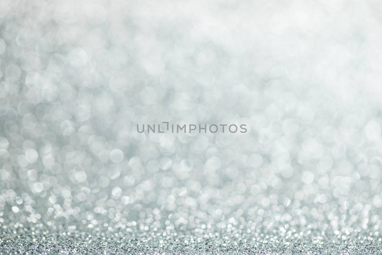 Shiny silver bokeh glitter lights abstract background, Christmas New Year party celebration concept