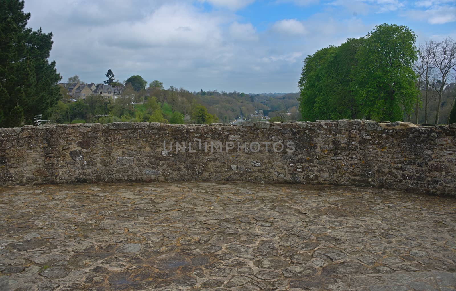 Top of stone fortress tower and landscape behind it in Dinan, France by sheriffkule