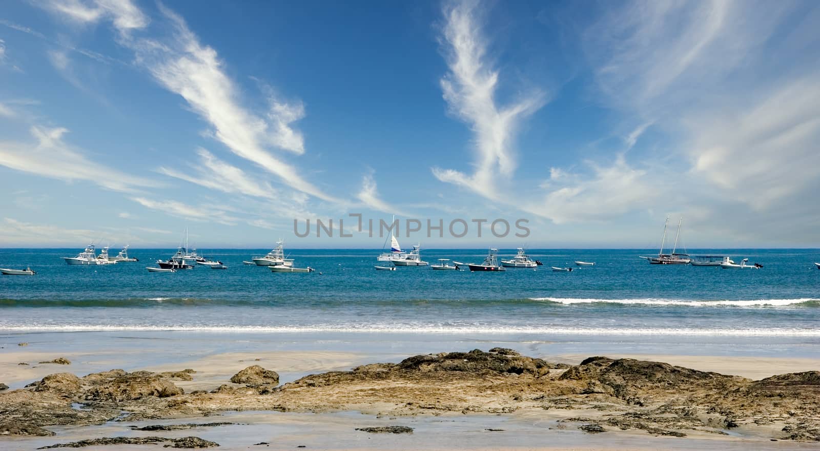 Boats and Sailboats Moored on Blue Water by dbvirago