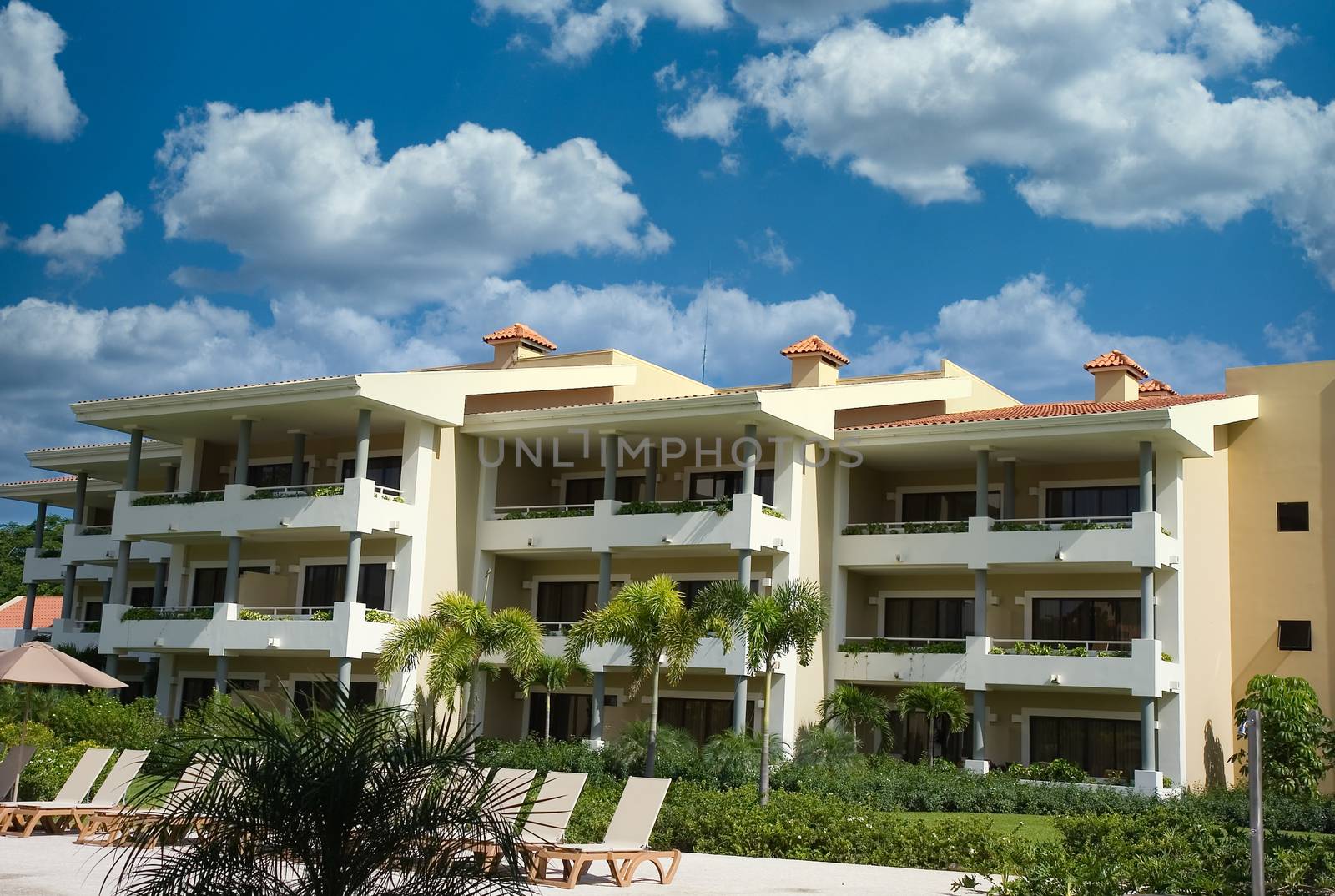 A tropical rsort building against a blue sky