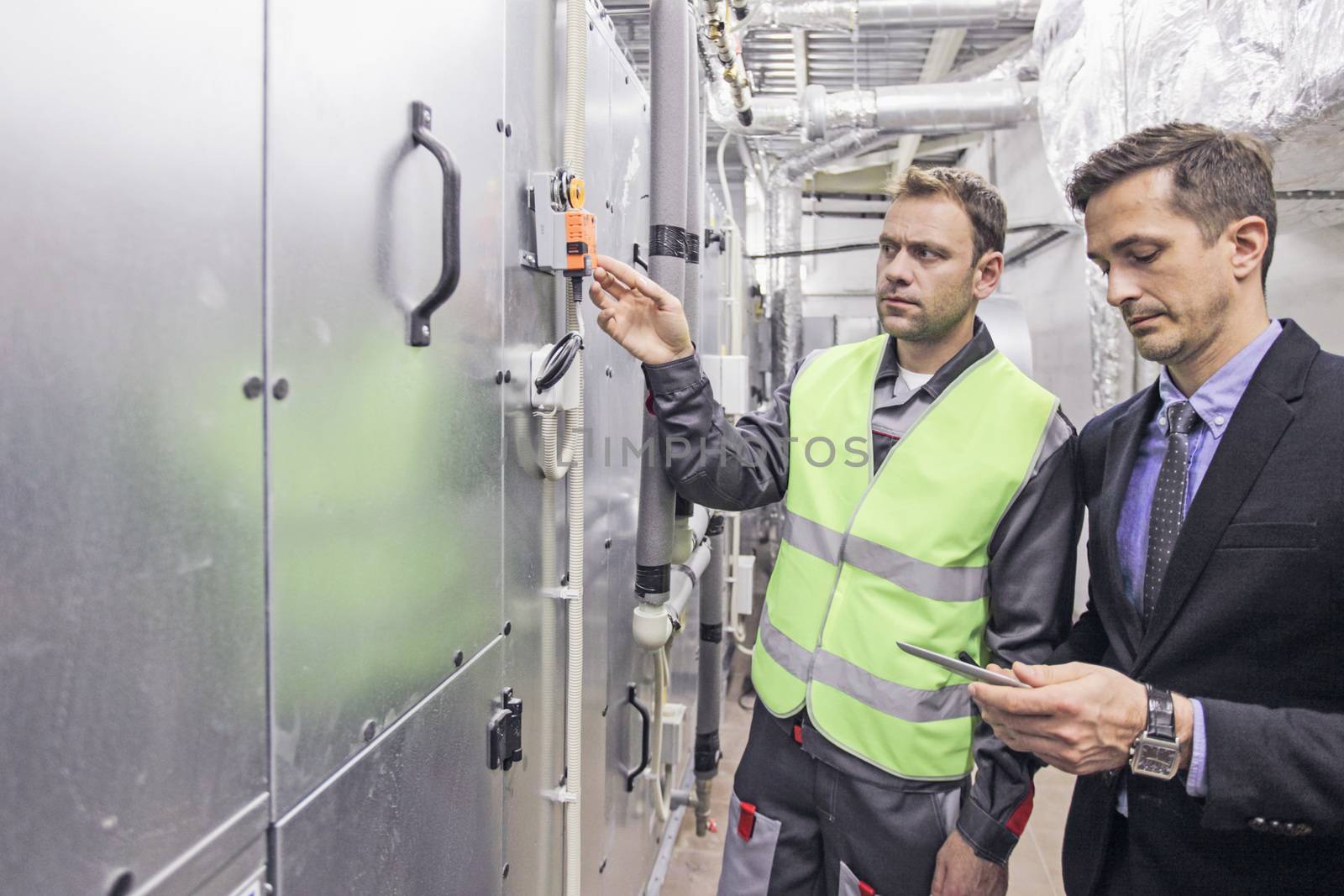 Electrician engineers working in electical cabinet control , switchboard operator