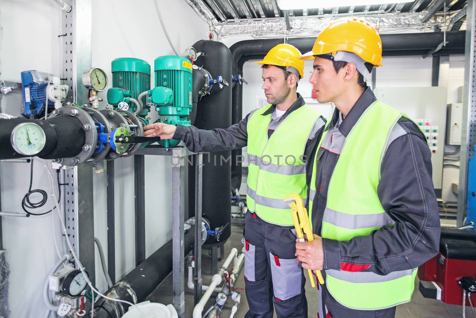 Workers check pipe monometer by ALotOfPeople