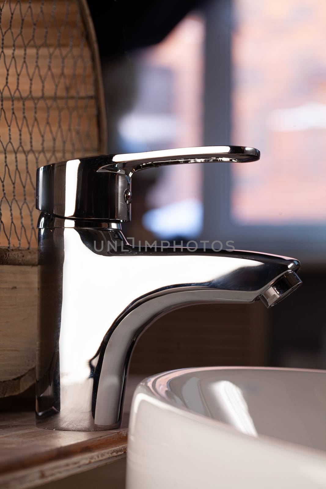 Metal water mixer and porcelain sink