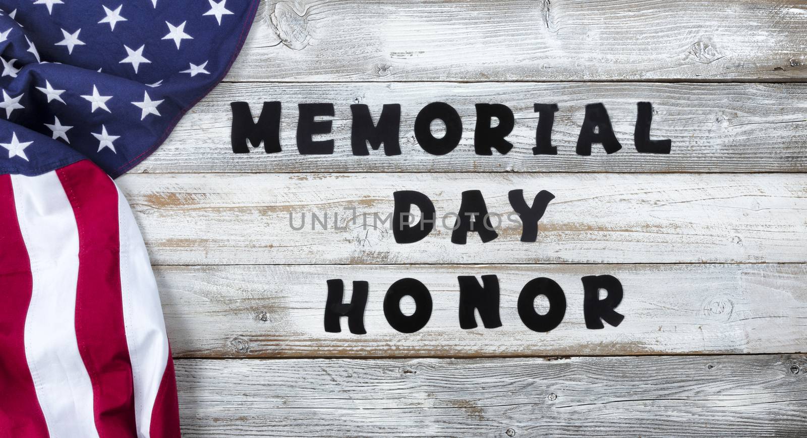 Waving United States Flag on left side of white rustic wooden with large text for Memorial Day with honor Background  