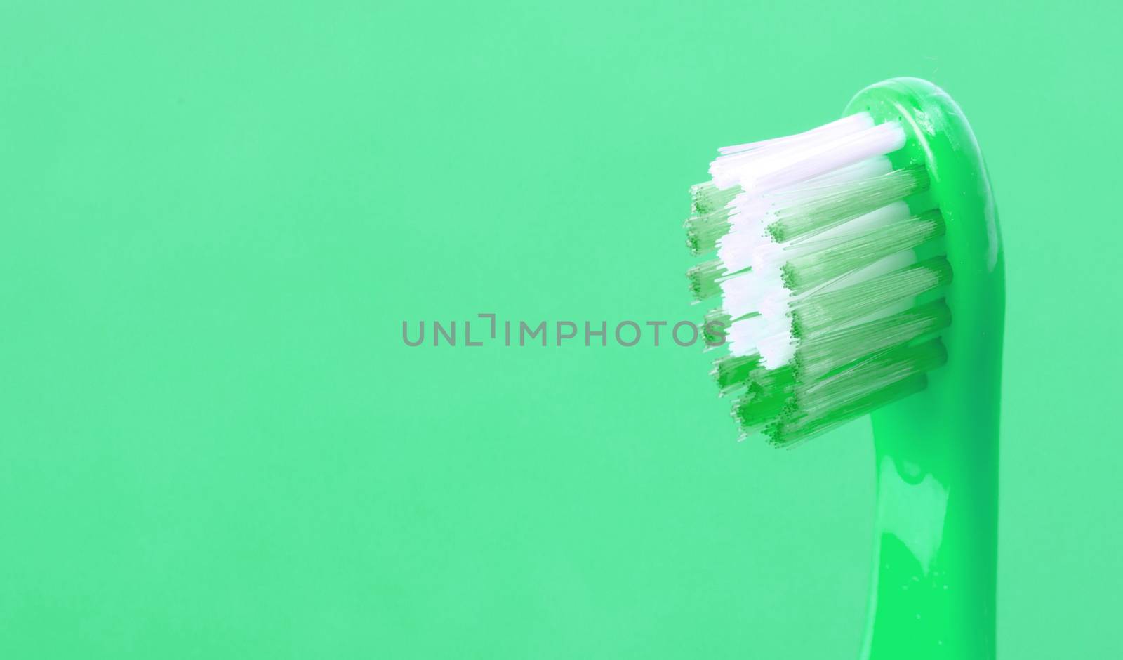 Dental care toothbrush isolated on green background