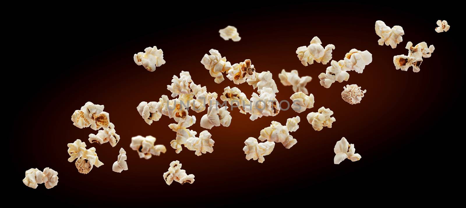 Popcorn isolated on black background. Falling or flying popcorn. Close-up by xamtiw