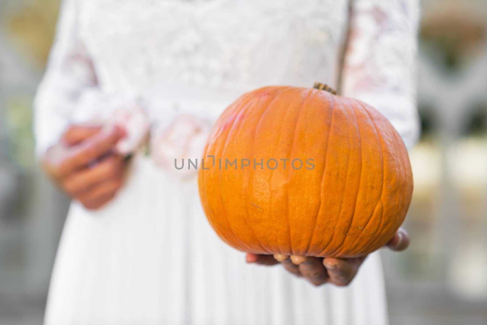 Halloween Ghost Bride holding pumpkin in her hands