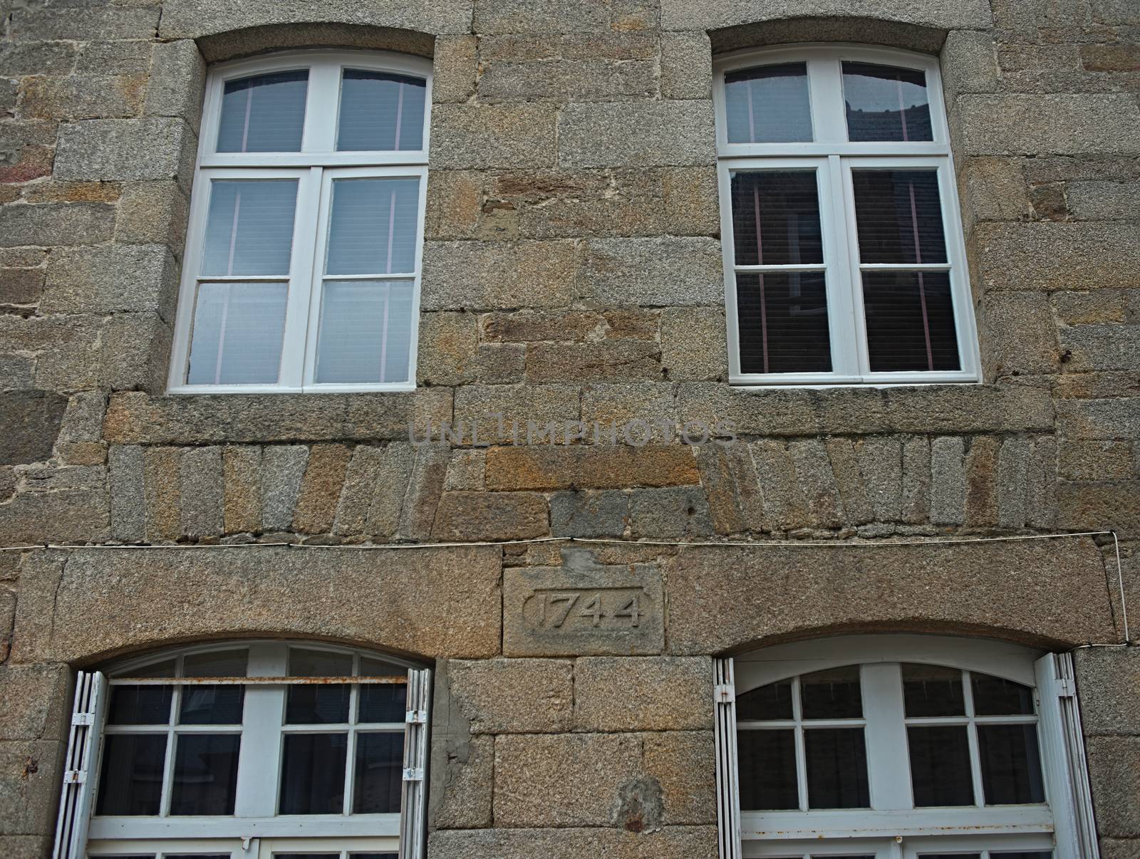 Traditional french stone building with many windows by sheriffkule