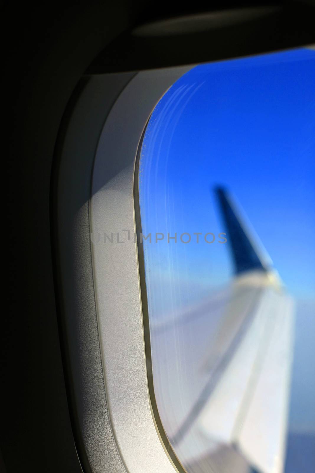 View from inside of plane through airplane window at wing by friday