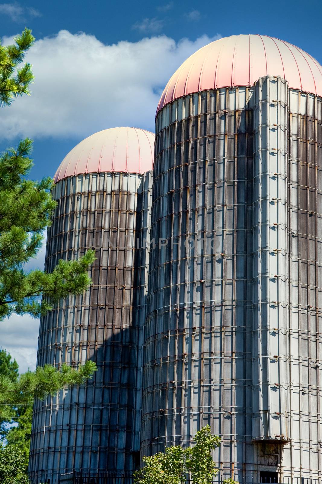 Two old grain silos under a blue sky