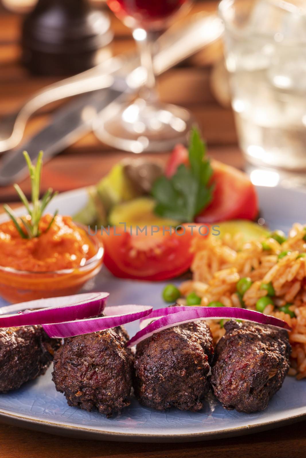 closeup of cevapcici with djuvec rice