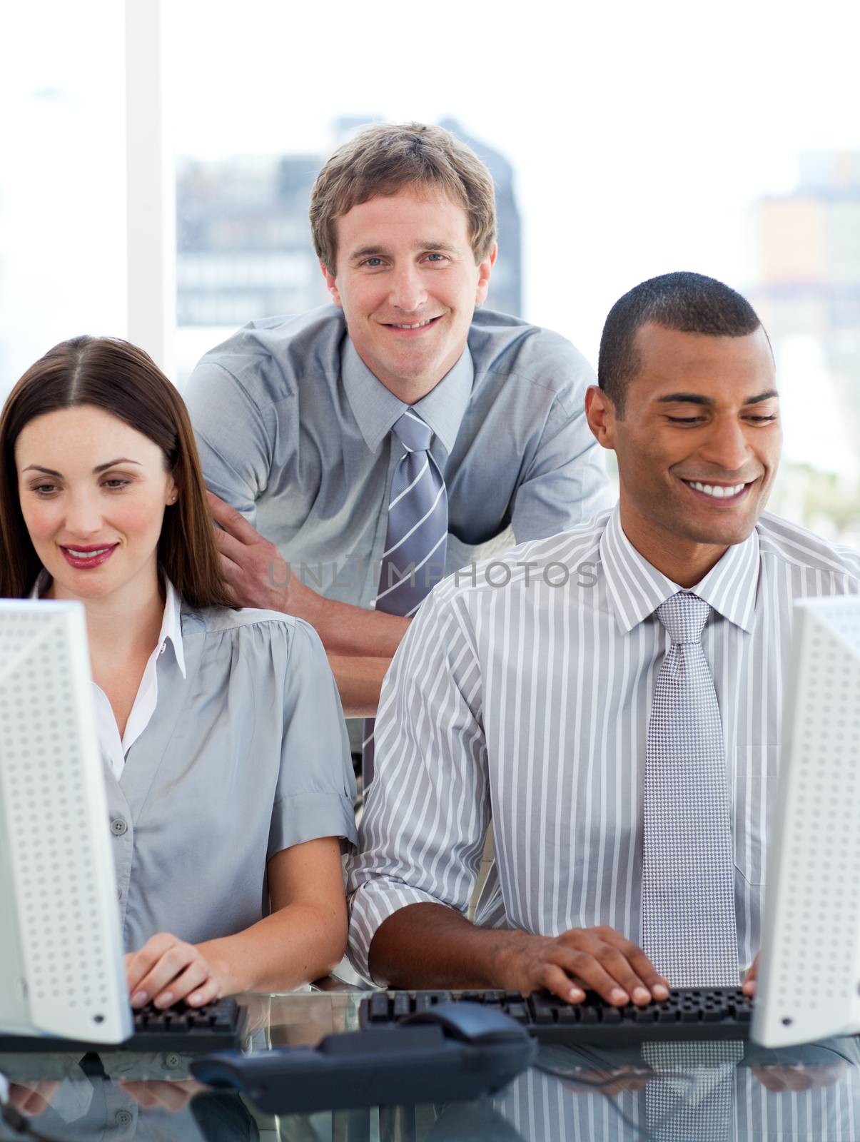 Young business group working at a computer in the office