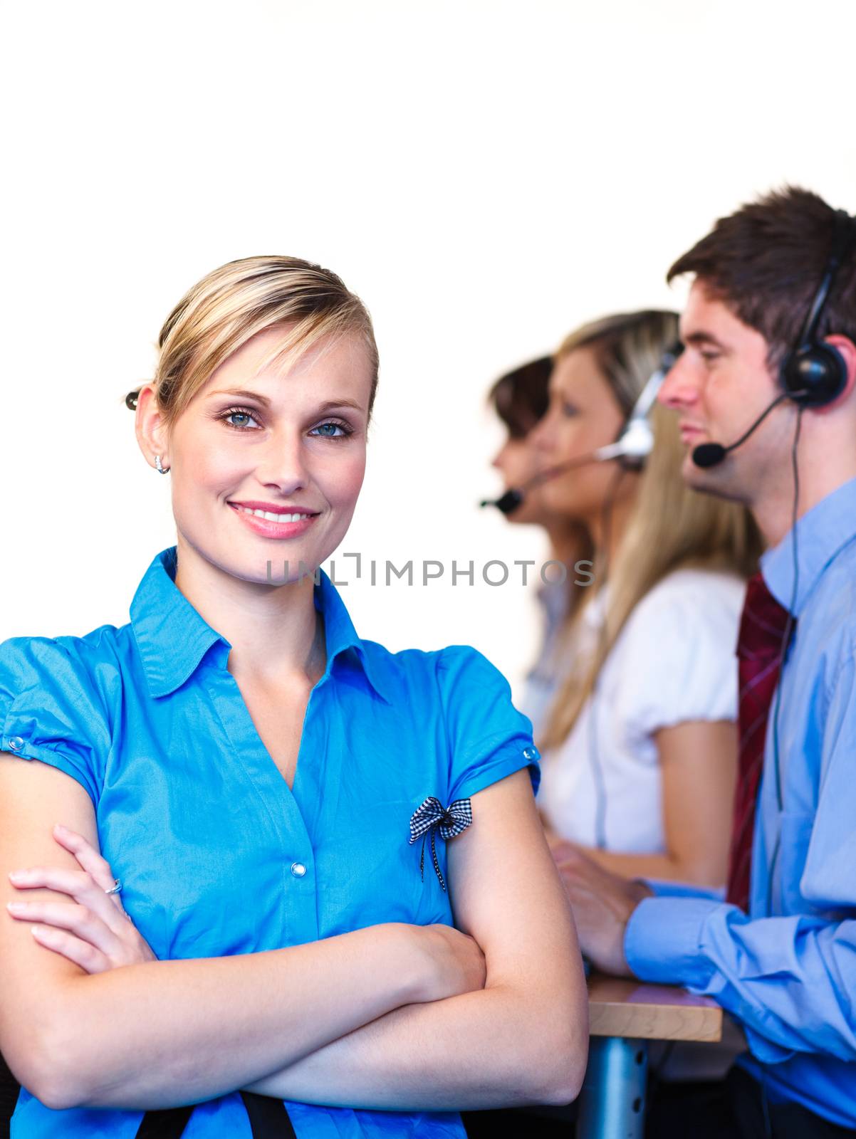 Blonde manager looking at the camera in a call center