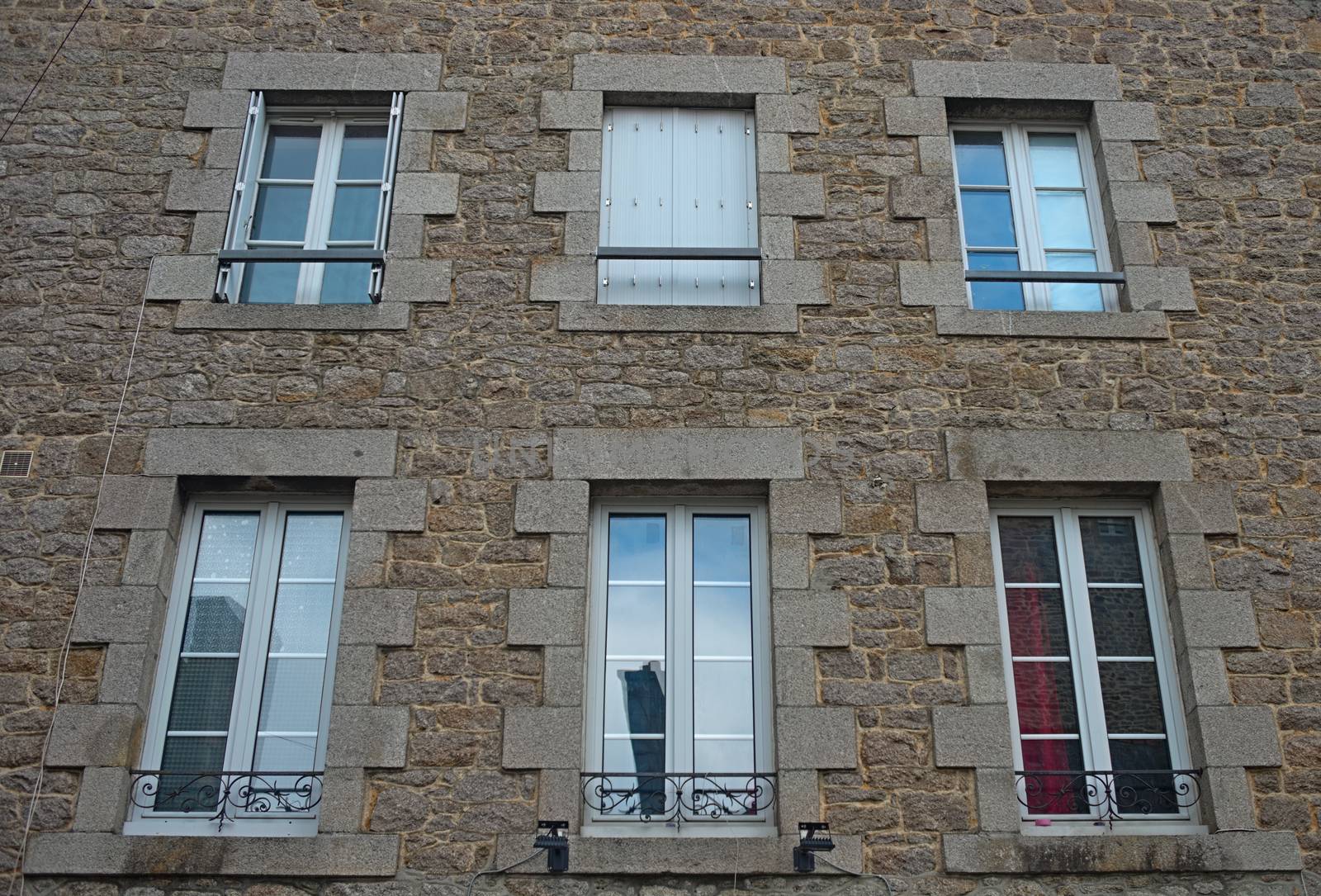 Traditional french stone building with many windows by sheriffkule