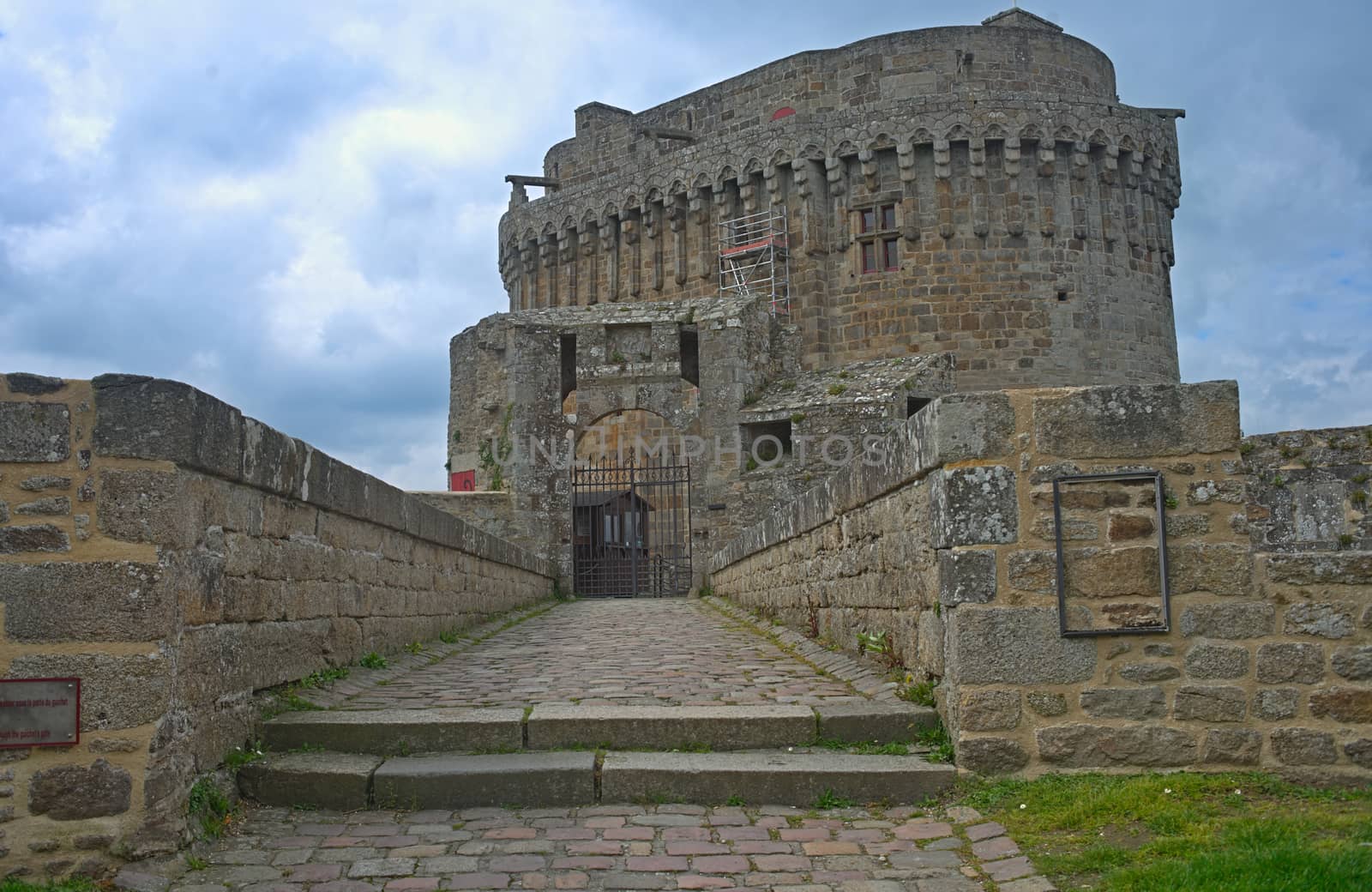 Big central stone tower with flag on top at Dinan fortress, France by sheriffkule