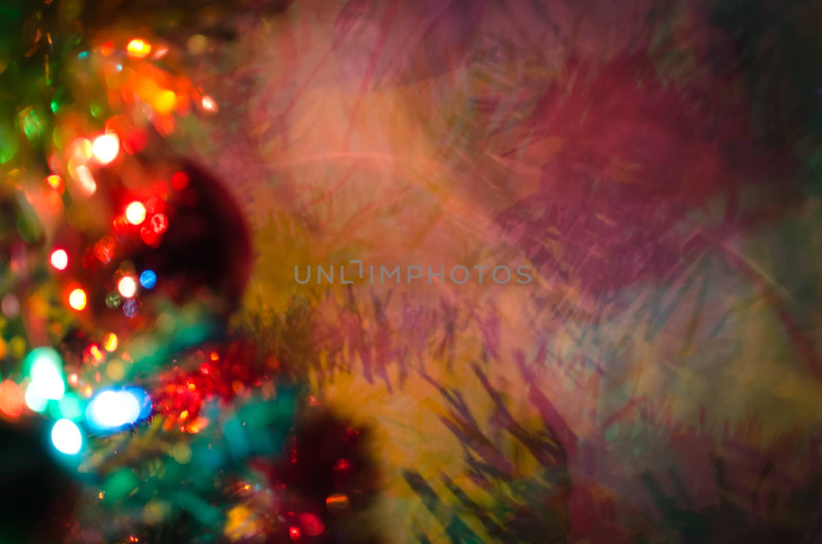 Magicall multi color figures made by light over Christmas tree balls and spumillion