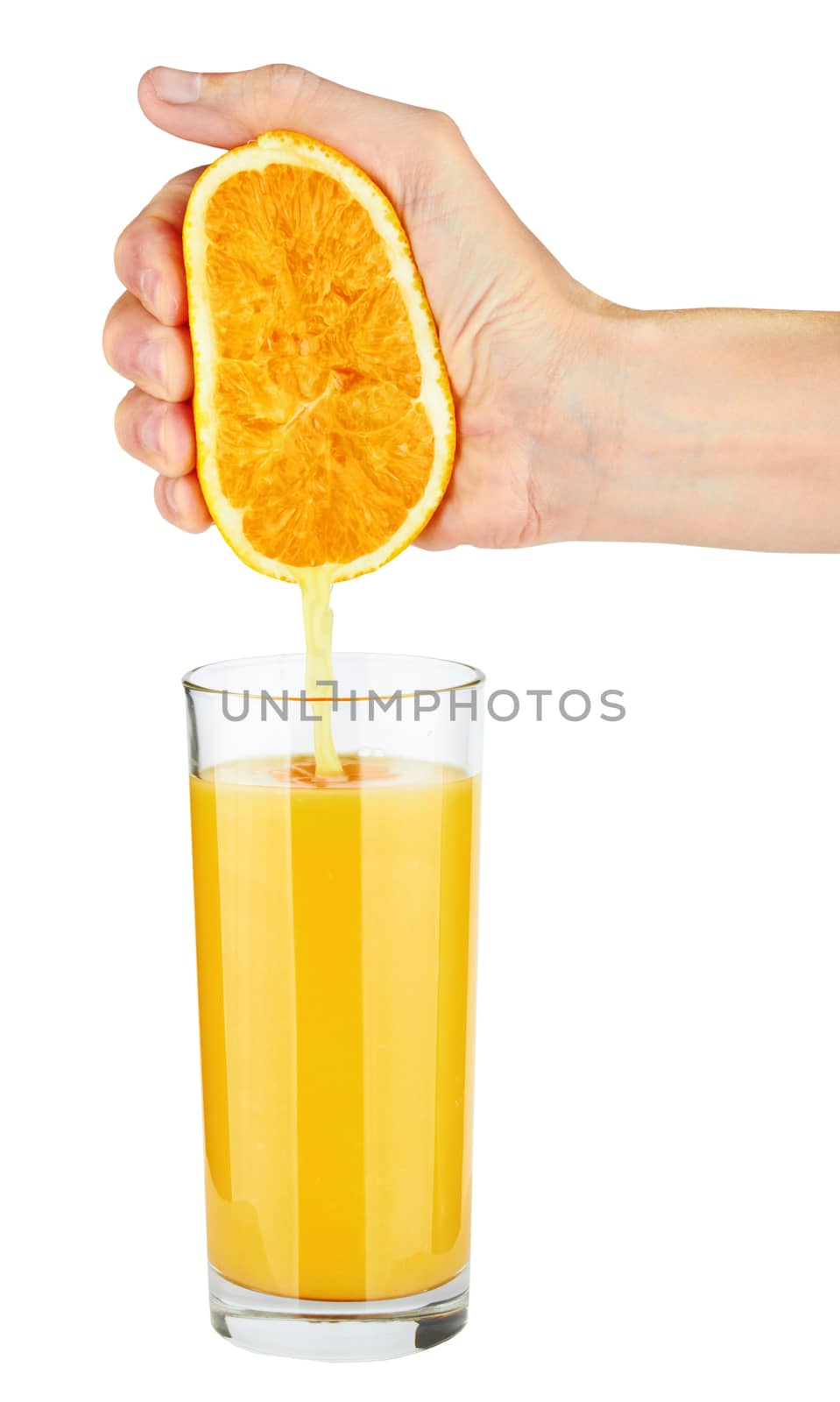 Pouring orange juice from orange into the glass isolated on white 