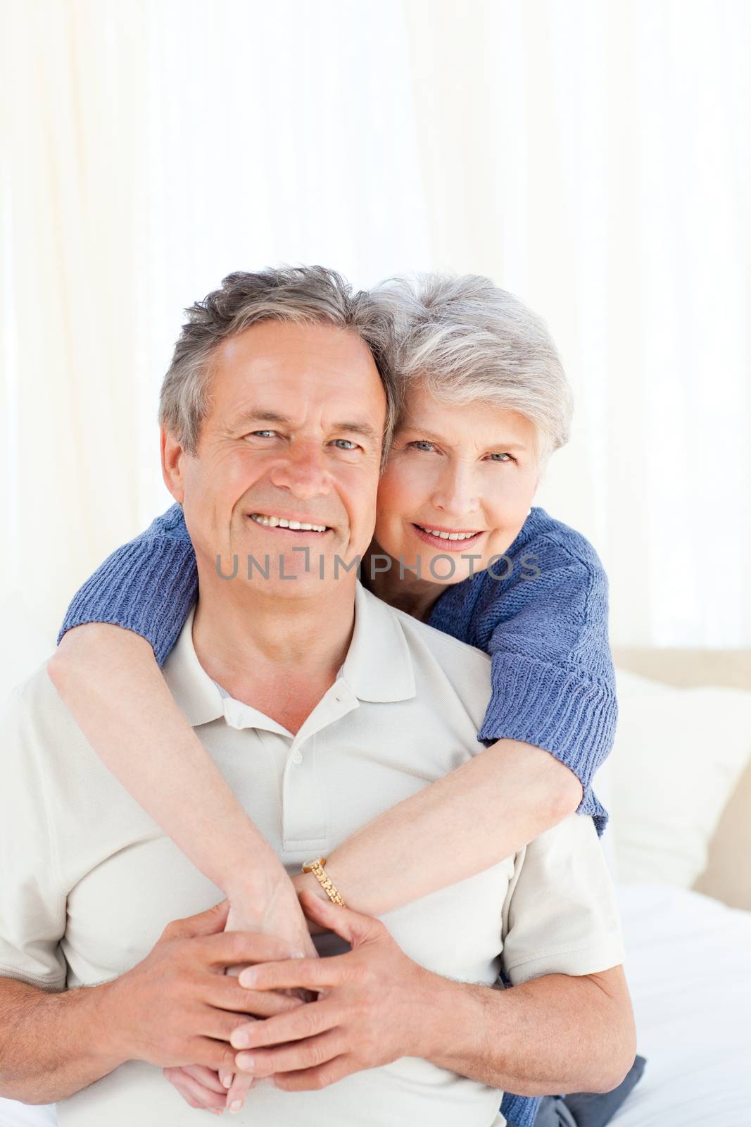 Senior couple looking at the camera at home