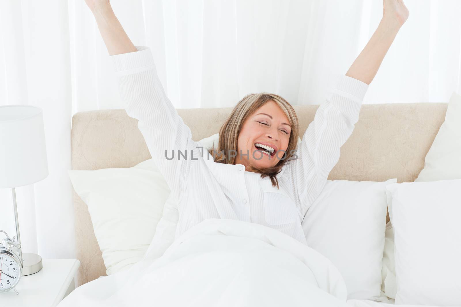 Happy woman in her bed by Wavebreakmedia