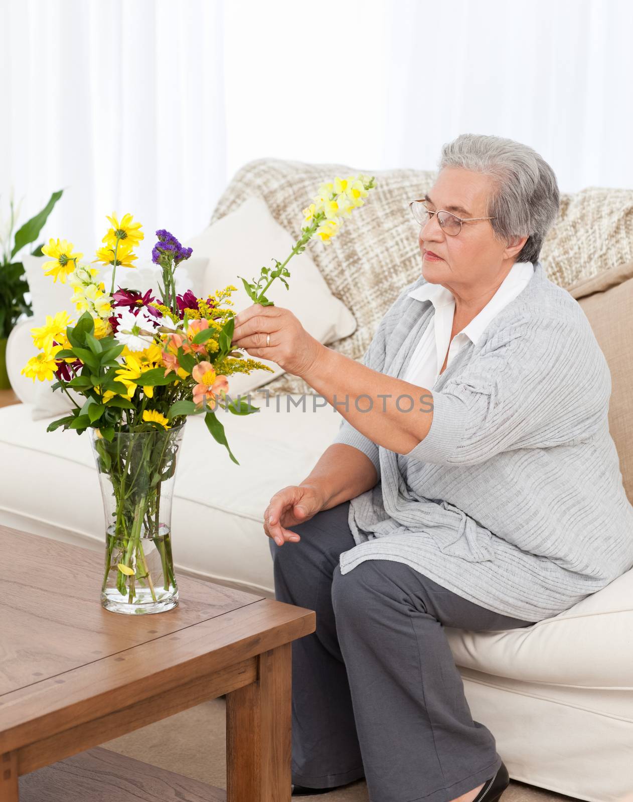 Senior woman with flowers  by Wavebreakmedia