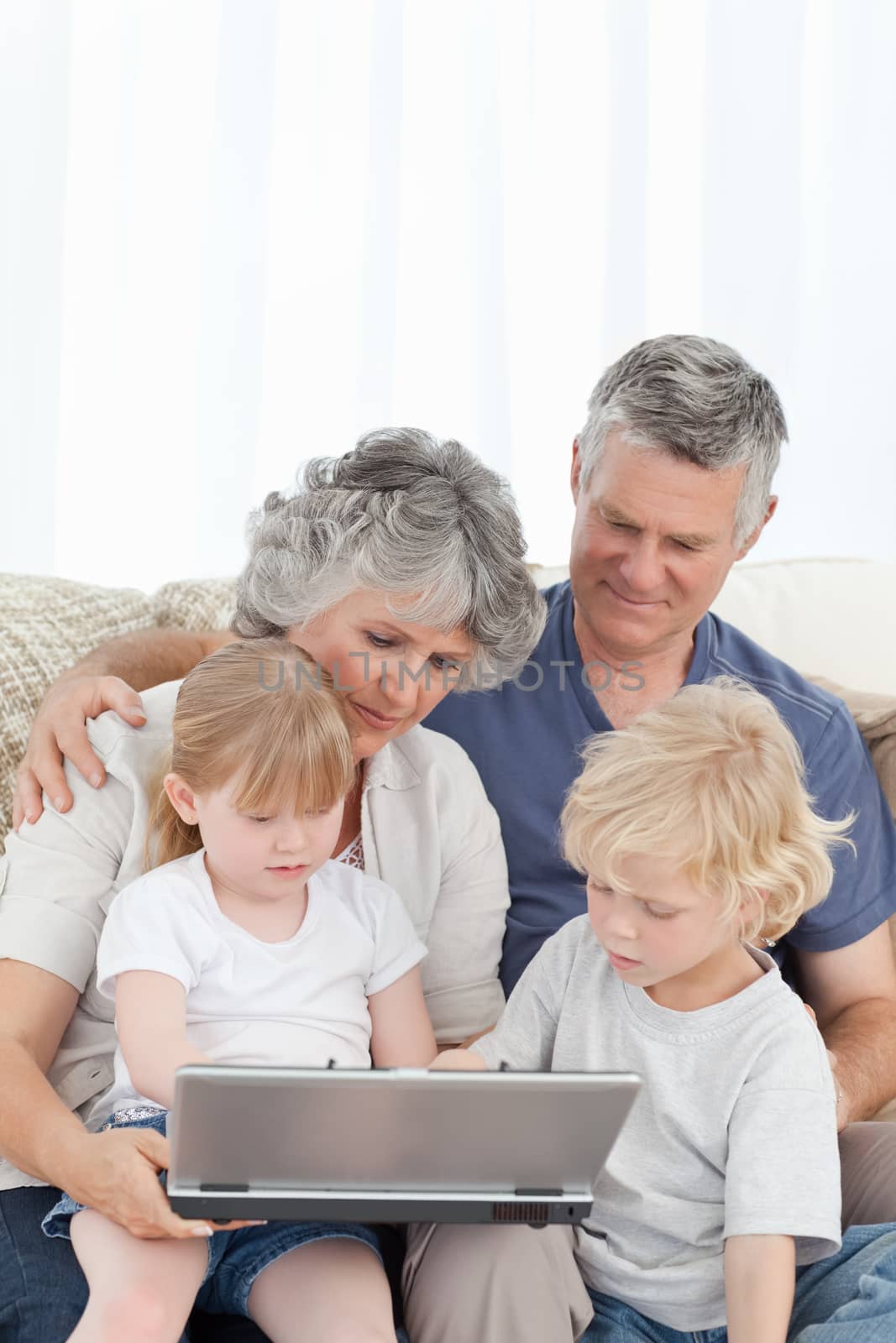 Adorable family looking at the laptop at home