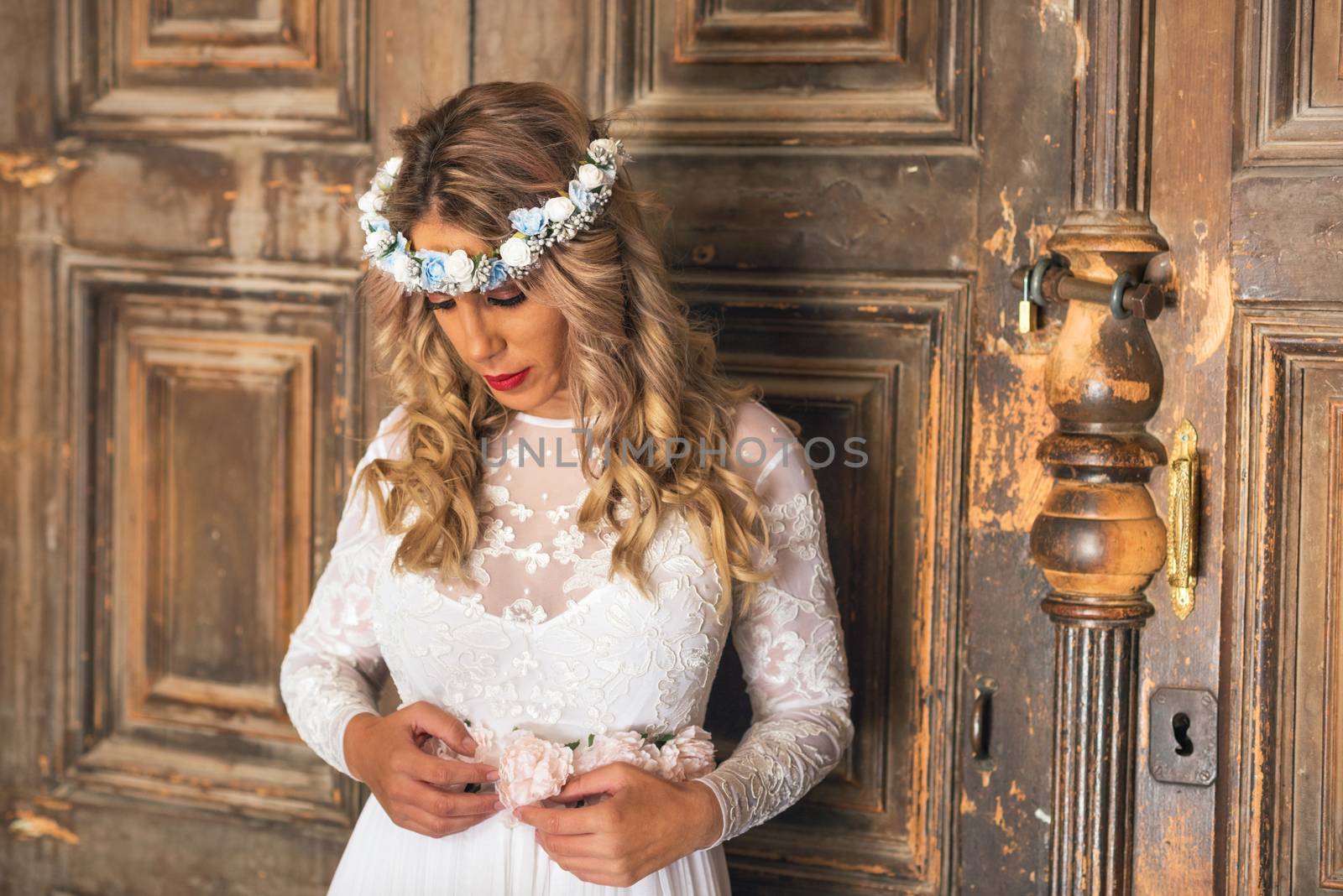 Beautiful bride portrait on old wooden door background