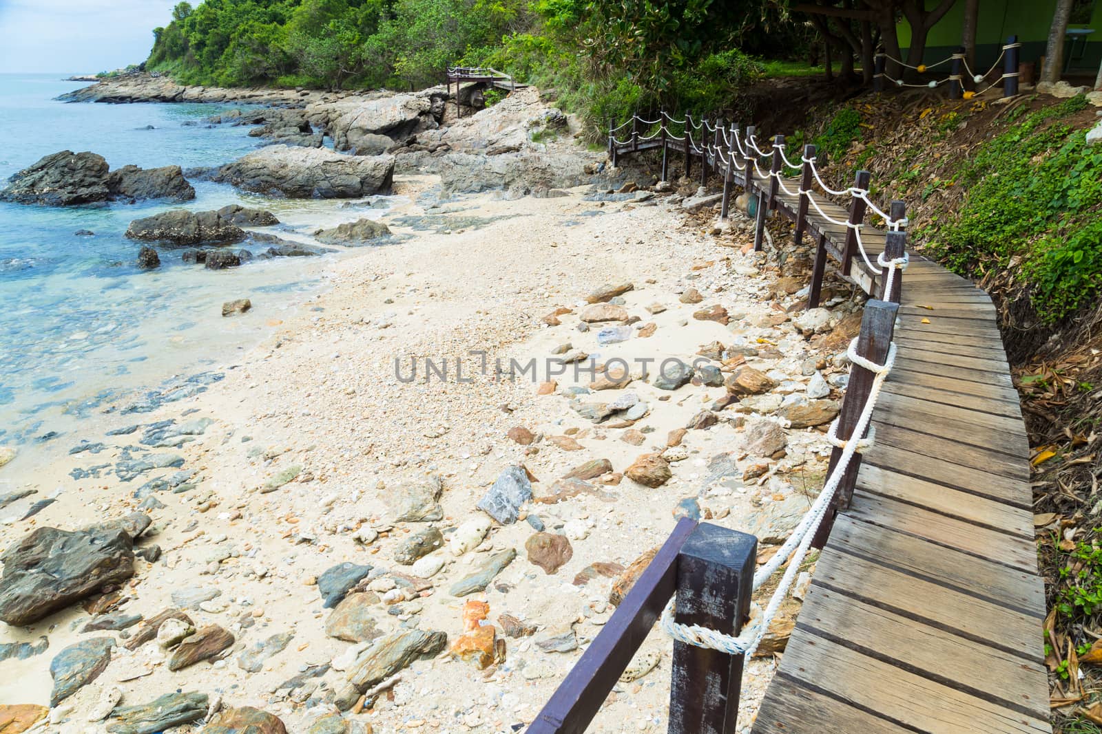 Wooden bridge to a tropical beach on island with blue sky, at khao laem ya mu koh samet island Rayong Thailand