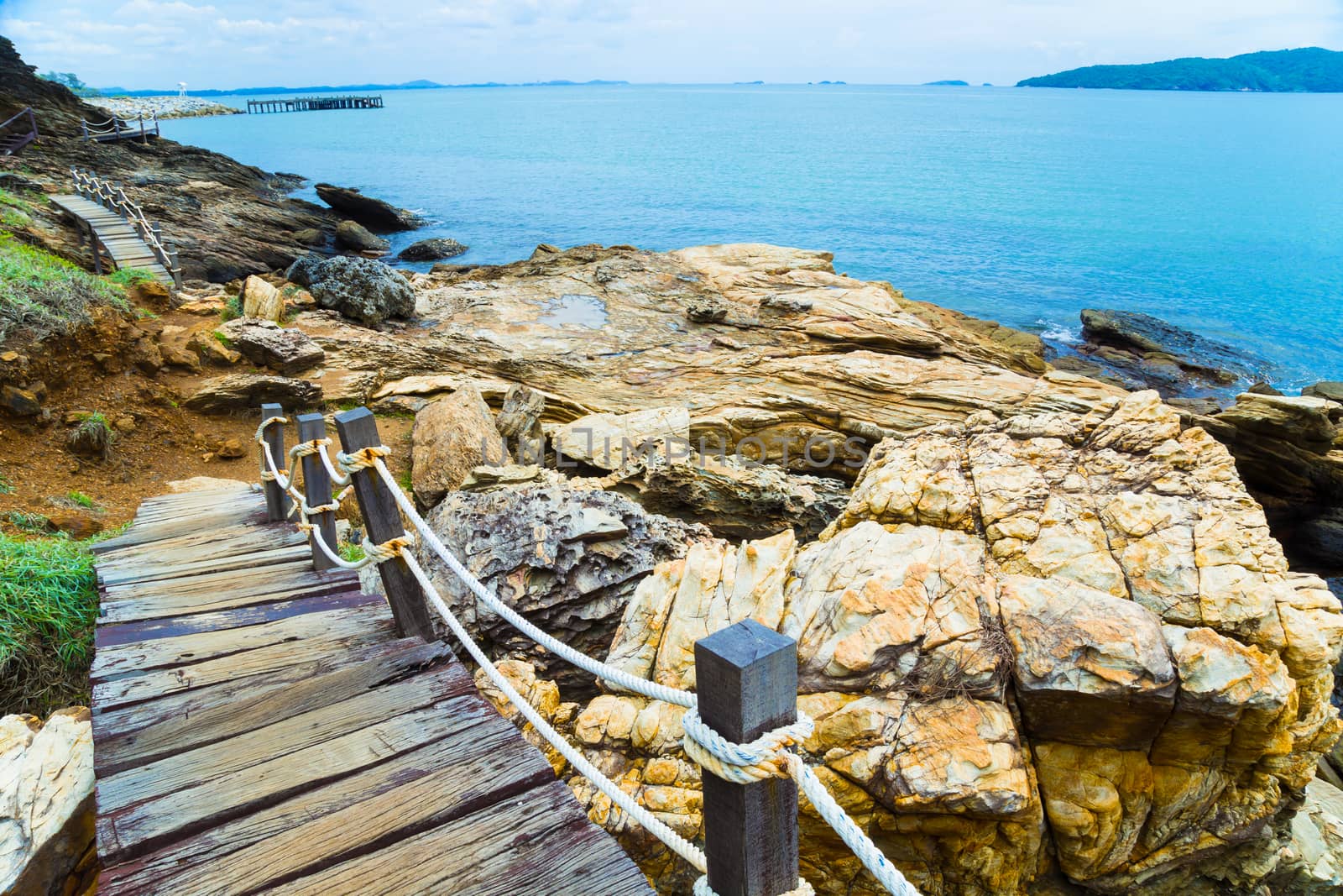 Wooden bridge to a tropical beach on island with blue sky, at khao laem ya mu koh samet island Rayong Thailand