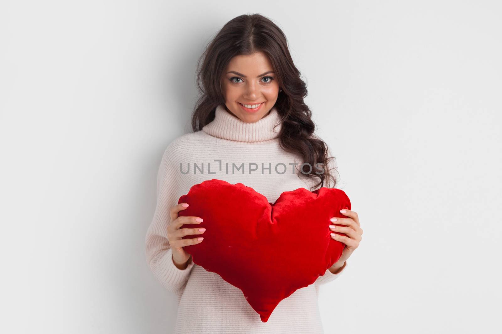 Beautiful woman with red pillow heart, valentine's day concept