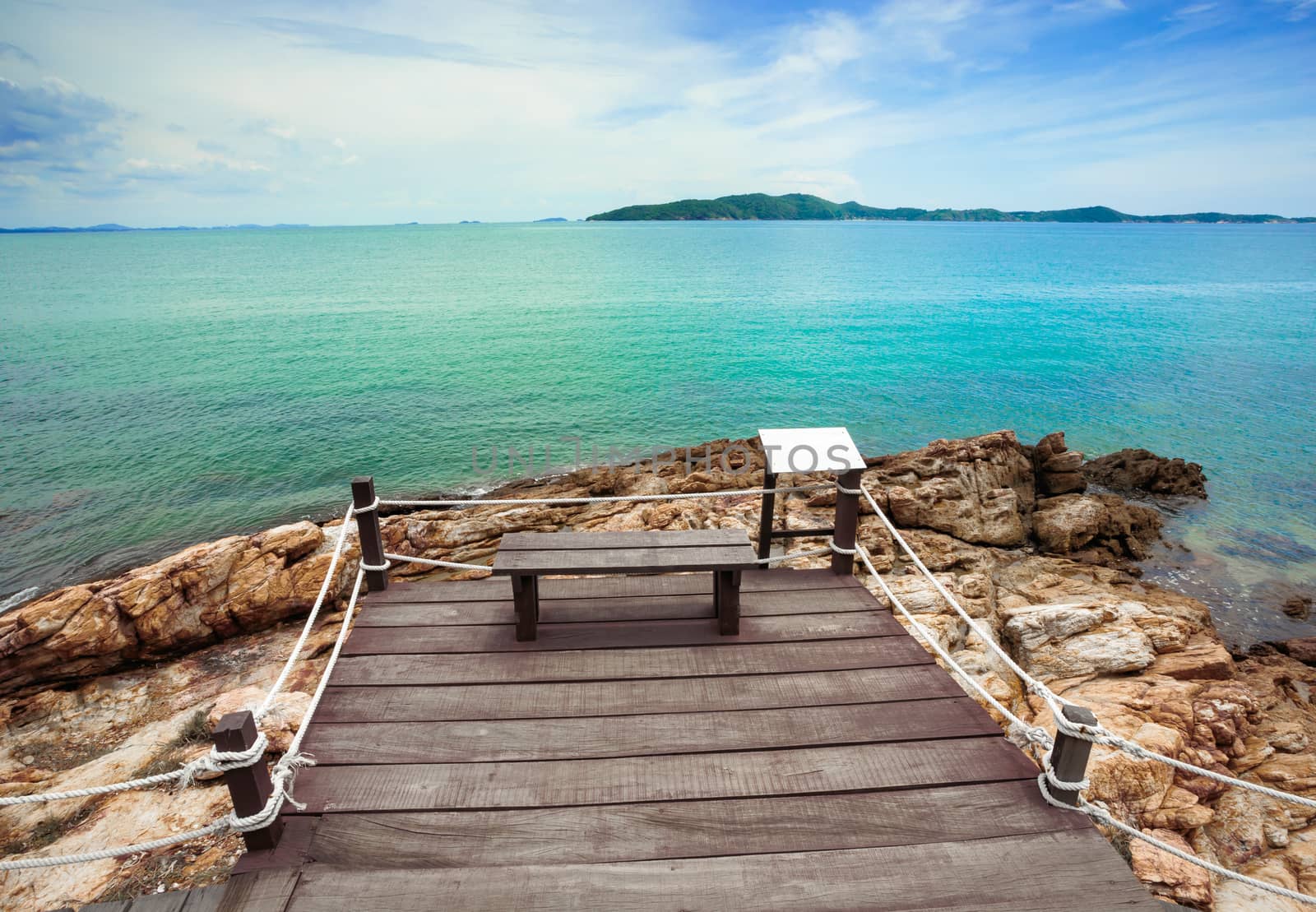 Wooden bridge to a tropical beach on island with blue sky, at khao laem ya mu koh samet island Rayong Thailand