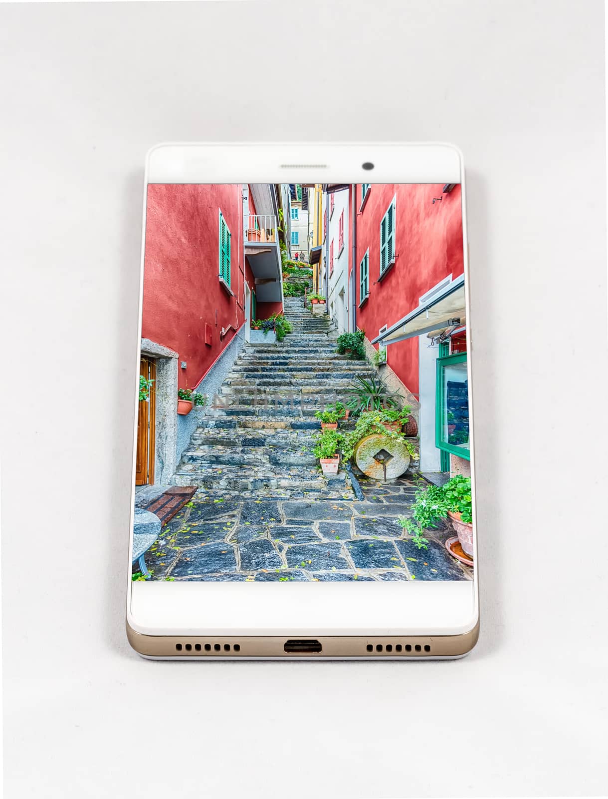 Modern smartphone with full screen picture of Varenna, Lake Como, Italy. Concept for travel smartphone photography. All images in this composition are made by me and separately available on my portfolio